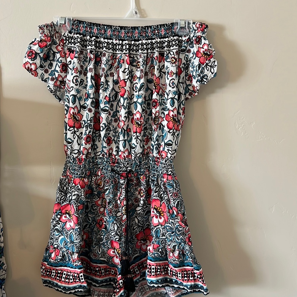 an off the shoulder romper, size small, little tassels to tie into a bow